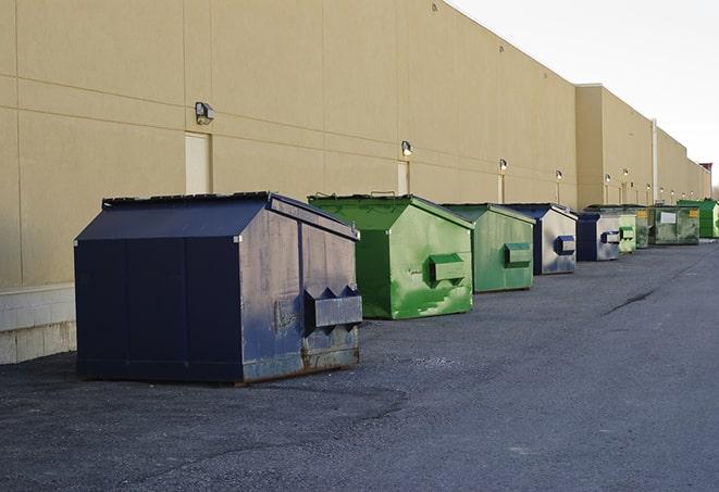 a construction dumpster on a work site filled with debris in Auburndale